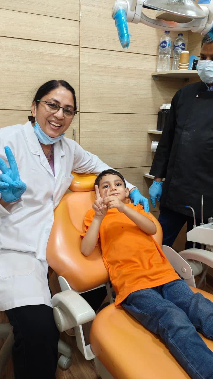 Happy child receiving tooth decay treatment at Root Care Dental Clinic, Gurugram