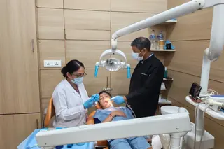 Pediatric dentist with child patient at Root Care Dental Clinic, Gurugram