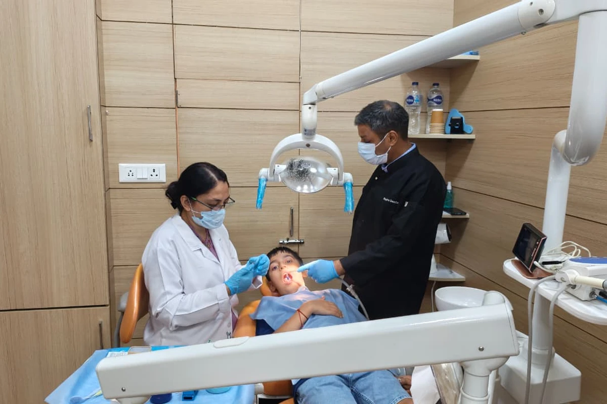 Pediatric dentist with child patient at Root Care Dental Clinic, Gurugram